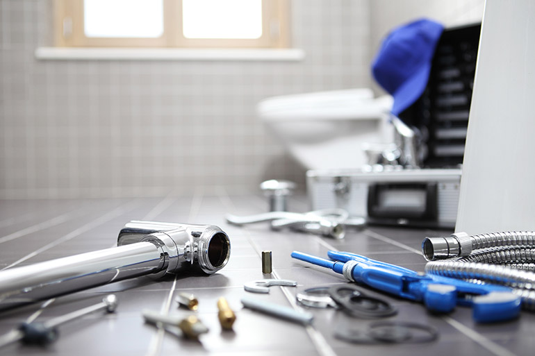 plumber tools and equipment in a bathroom, plumbing repair servi